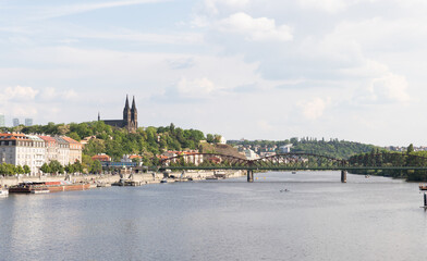 View from the embankment of Vltava river to the Railway Bridge and Saints Peter and Paul Basilica in Vysehrad in Prague in Czech Republic