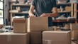 © kimly - A person packing boxes with care and attention to detail, preparing them for shipment.
