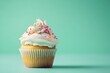 © Dai - A cute cupcake on a soft mint green backdrop, decorated with playful toppings and a happy expression. Ample space above the cupcake for effective advertising messages.