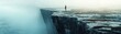 © Chanoknan - A solitary figure stands on the edge of a majestic cliff, shrouded in mist, evoking a sense of wonder and introspection.