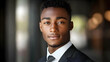 © Siasart Stock - A close-up portrait of a young African American man in a black suit and white shirt looking directly at the camera.