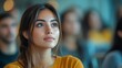 © The Little Hut - Focused young attractive Latina listening to lecture in classroom with group Postgraduate education concept : Generative AI
