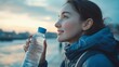 © The Little Hut - Woman drinking water and exercise in outdoor for hydration music and runner or workout break Female person profile and relax on promenade cloudy sky and bottle of mineral liquid for nu : Generative AI
