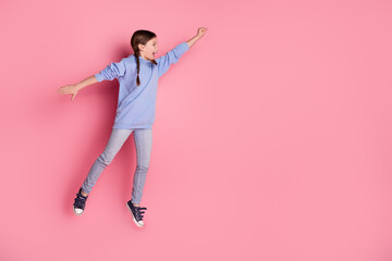 Poster - Full size photo of lovely small schoolkid jump empty space wear hoodie isolated on pink color background