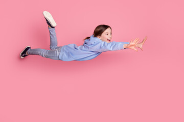 Poster - Full size photo of lovely small schoolkid flying wear hoodie isolated on pink color background