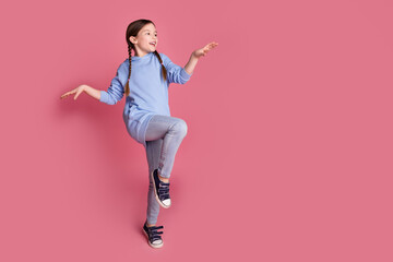 Poster - Full size photo of lovely small schoolkid dance empty space wear hoodie isolated on pink color background