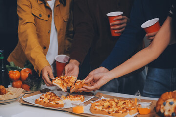 Group of young friends eating pizza.Home party.