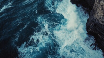 Wall Mural - Dramatic Aerial Shot of Waves Colliding with Cliffs