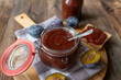 © Angelika Heine - German plum butter or Pflaumenmus fresh and homemade cooked in a jar on wooden table background