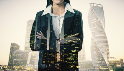 Poster - Headless young european businesswoman with folded arms on abstract blurry city background. Future, success and growth concept. Double exposure.