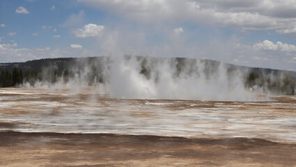 Wall Mural - This is a picture of a geyser, a hot spring that erupts water and steam into the air.

