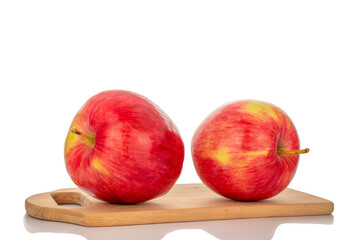 Two red apples on a wooden kitchen board, macro, isolated on a white background.