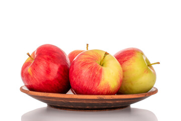 Wall Mural - Several red apples on a clay plate with a knife, macro, isolated on a white background.