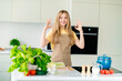 © deagreez - Photo of charming cheerful nice girl cooking meal okey sign house modern kitchen daylight indoors