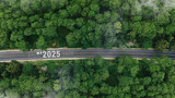 Aerial top view road in forest with car to start the new year 2025 Goal plan action, Business target and growth strategy. Business annual plan and development for achieving goals and success.