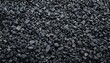 © Unic - Black road stones gravel texture, rocks for construction, dark background of crushed granite gravel, small rocks, closeup