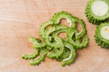 Sliced bitter gourd on cutting wooden board, Food ingredient