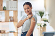 © Azee Jacobs/peopleimages.com - Happy woman, portrait and vaccine with plaster for healthcare, cure or recovery at home. Young female person with smile or bandaid on arm for vaccination, protection or medical injection at house