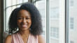 © Monkey Business - Head And Shoulders Portrait Of Smiling Young Businesswoman Standing By Window In Office