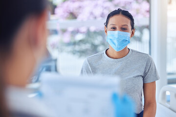 Wall Mural - Healthcare, woman and face mask with doctor in consultation, hospital or clinic checkup. Clipboard, document and patient with medical professional for pandemic protection for covid compliance or care