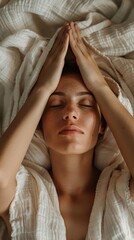 Poster - Two hands rest on the face of a woman, creating a serene atmosphere of relaxation and tranquility in a softly lit room
