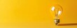© Wall - A yellow background hosts a light bulb and two pencils