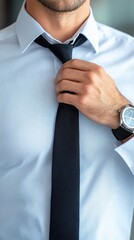 A close-up of a man adjusting his tie, showcasing a modern business style and sophistication.