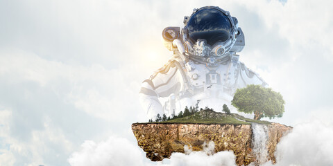 Wall Mural - astronaut against cloudy sky background