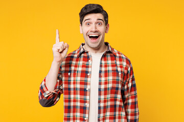 Poster - Young insighted smart proactive happy Caucasian man wears red checkered shirt casual clothes holding index finger up with great new idea isolated on plain yellow orange background. Lifestyle concept.