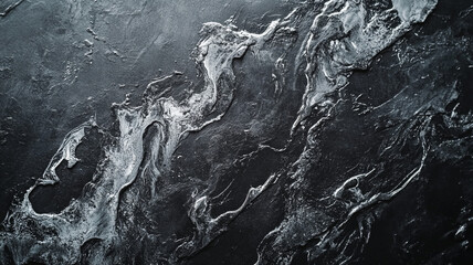Poster - Abstract black and white texture resembling waves on a dark surface in a dimly lit environment