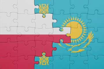 puzzle with the colourful national flag of kazakhstan and flag of poland.