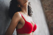 © deagreez - Cropped photo of attractive young girl breast bra shopping wear red fashion lingerie isolated concrete wall background no filter