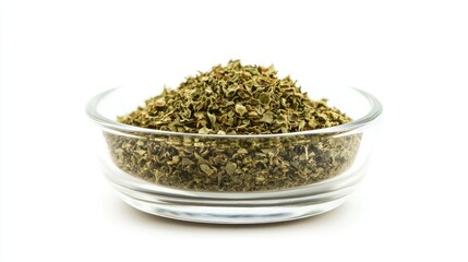 Wall Mural - A small glass bowl of dried oregano, isolated on a white background, with the crushed herbs piled high inside the clear container.