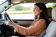 © Антон Сальников - This is a happy, smiling European woman driving a brand new car, looking at the rearview mirror and with a big smile on her face.