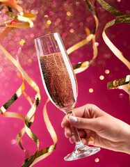 Champagne glass with colorful background with confetti, celebration background with copy space, concept of celebration