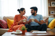 © MOTOKO Stock - Joyful Hindu Couple Sharing Coffee: Perfect for Ads on Home Decor, Relationship Wellness, or Coffee Brands
