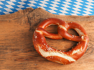 Tasty Bavarian pretzel on a wooden board, Traditional German food