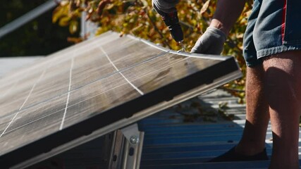 Wall Mural - Connection and installation of solar panels. Workers attach solar panels. Technicians install solar panels on a metal stand. Workers install photovoltaic solar panels on the roof of a house.