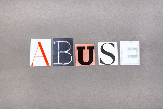 The word Abuse in magazine snippets on grey background