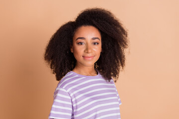 Wall Mural - Portrait of pretty young girl wavy hairdo wear striped t-shirt isolated on beige color background