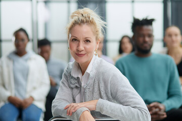 Wall Mural - young attractive business woman, teacher or trainer-mentor, looking at the camera