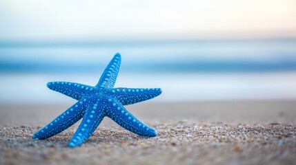 Wall Mural - Blue Starfish on Sandy Beach with Ocean Background - A single blue starfish sits on a sandy beach with the ocean in the background, symbolizing tranquility, peace, the ocean, and summer.