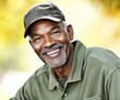 © Bay - Senior man in a green cap smiling warmly outdoors during daylight