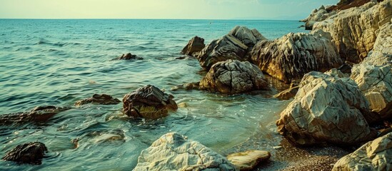 Wall Mural - Various rock textures can be observed along the beach, creating a picturesque scene with plenty of copy space image.