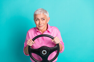 Sticker - Photo of nice aged woman hold wheel look empty space wear pink shirt isolated on teal color background