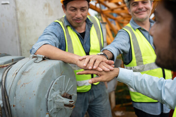 Wall Mural - Hand touching team engineers man worker checking machine and use tablet computer with spare crane background	