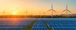 © Tanakorn - Landscape showcasing renewable energy with wind turbines and solar panels under a vibrant sunset sky.