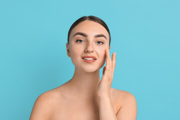 Sticker - Face massage. Beautiful young woman with healthy skin on light blue background