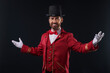 © New Africa - Portrait of showman in red costume and hat on black background