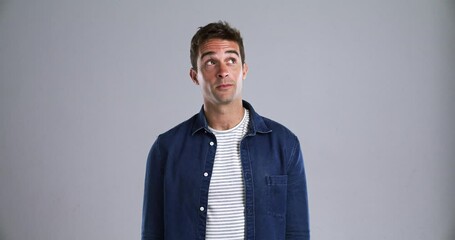 Poster - Face, smile and a young man thinking in studio isolated on gray background to relax while feeling positive. Portrait, idea and confident with a happy person from Brazil looking carefree or natural